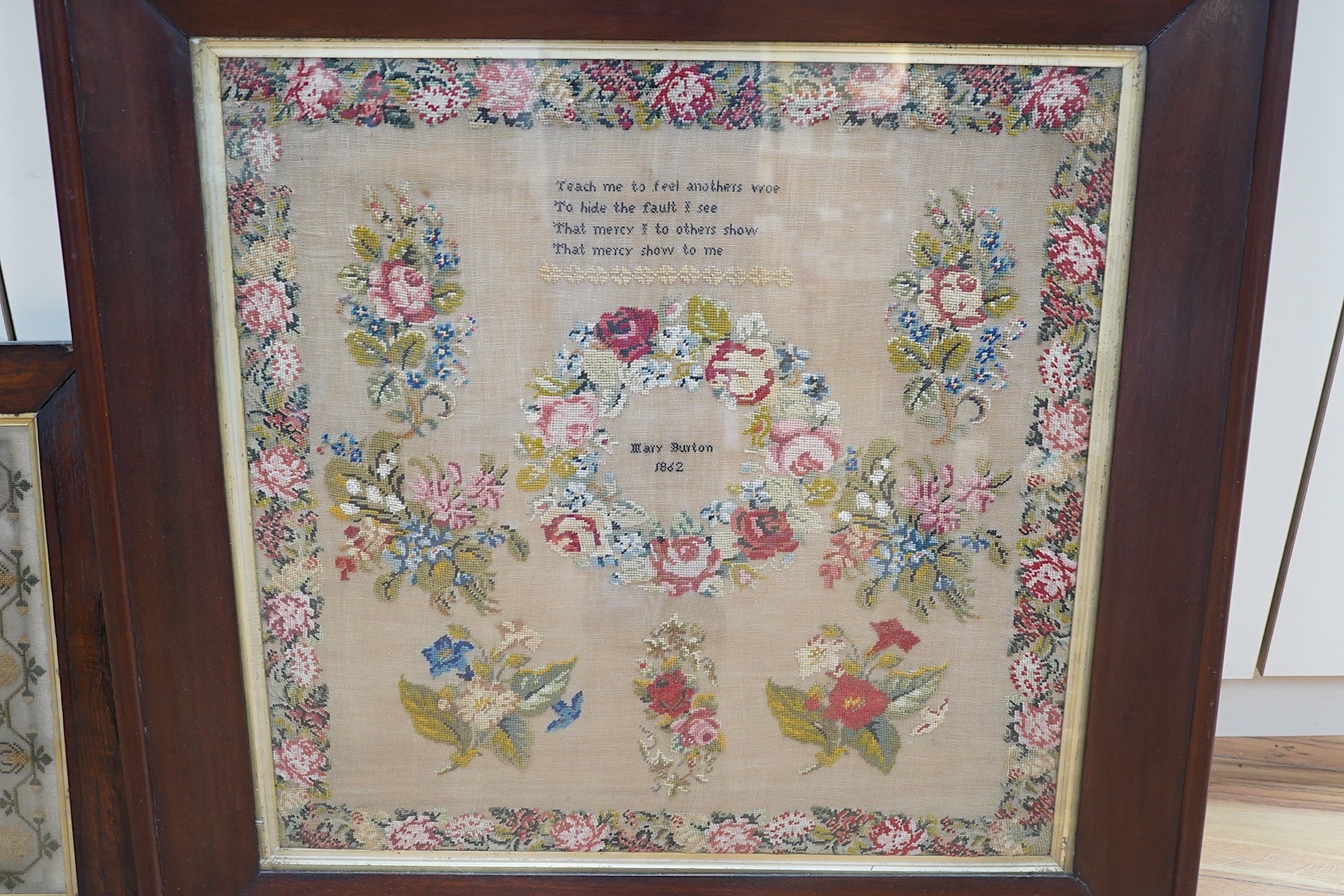 Two Victorian framed samplers; a large colourful floral sampler with short verse by Mary Burton 1862 and a smaller sampler by Julia Warner aged 13, dated 1846?, large 1862 sampler 59cm wide x 61cm high. Condition - large